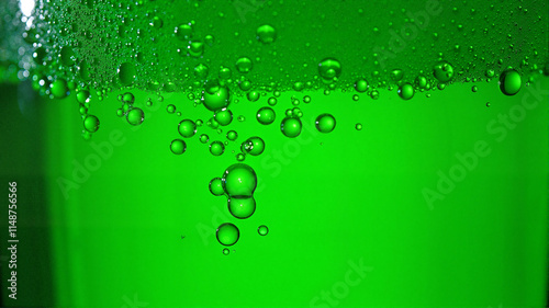 Close-up of green beer bubbles with foam detail photo