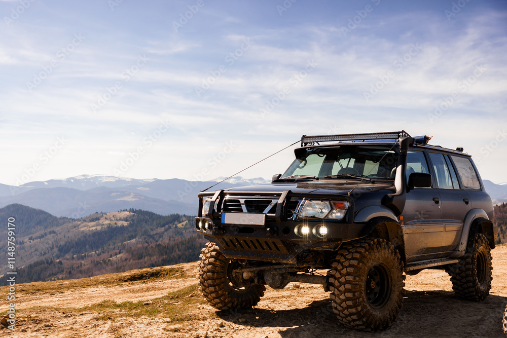 Fototapeta premium Off-Road Adventure: Rugged SUV on Mountain Terrain