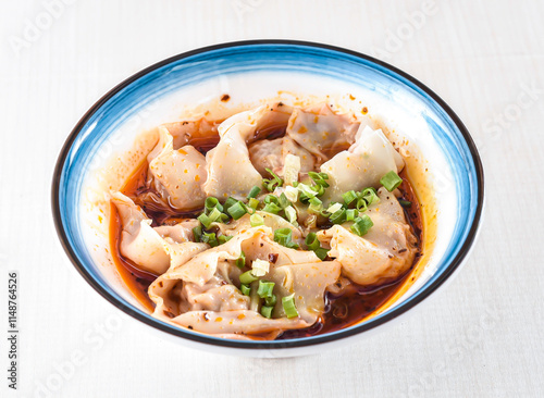 Spicy Wonton Soup in red oil with scallions served in bowl isolated on white background side view of hong kong food