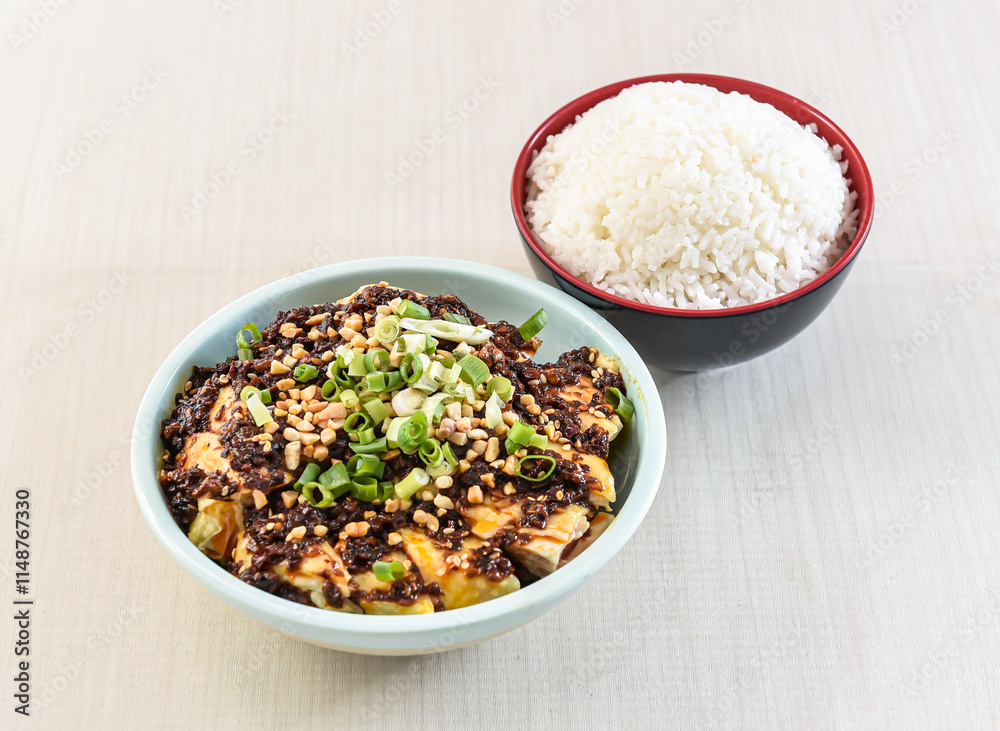Saliva chicken with white rice topped with nuts served in bowl isolated on white background side view of hong kong food Saliva chicken with white rice topped with nuts served in bowl isolated on white background side view of hong kong food