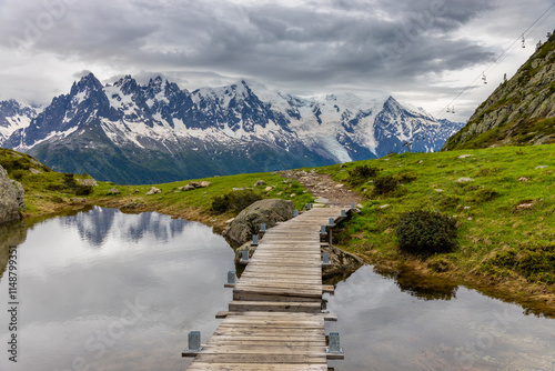 Nasty weather in the Alps. Dark cloudy sky and overcast before the rain and storm. Stormy weather. Snow and rocky summits of the alpine peaks inside the cloud. Aiguilles du Chamonix in autumn 