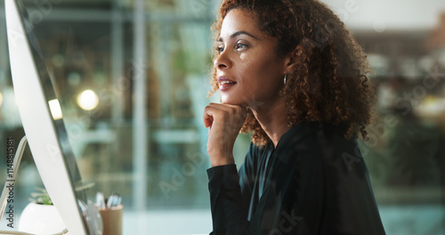 Woman, computer and thinking in office at night, accountant online and monitor economy growth. Female person, professional and ideas for finance in workplace, review budget and website for insight