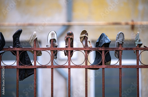 Shoes hanging on the fence