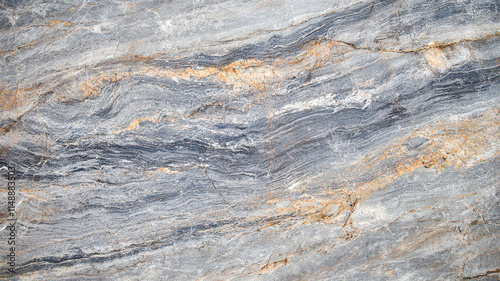 A smooth stone surface showcases neutral gray tones with natural veins and a subtle texture, creating an elegant and timeless look, ideal for upscale designs and sophisticated environments.