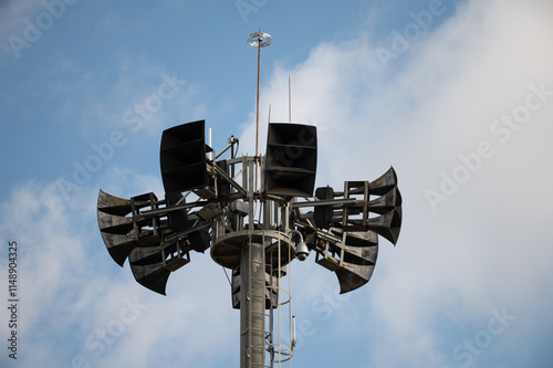 Detail of the upper part of a speaker and communications tower where large events are held, the tower has speaker antennas, horns, security cameras and other telecommunication devices photo