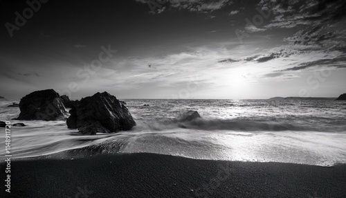 black and white seashore scene at sundown