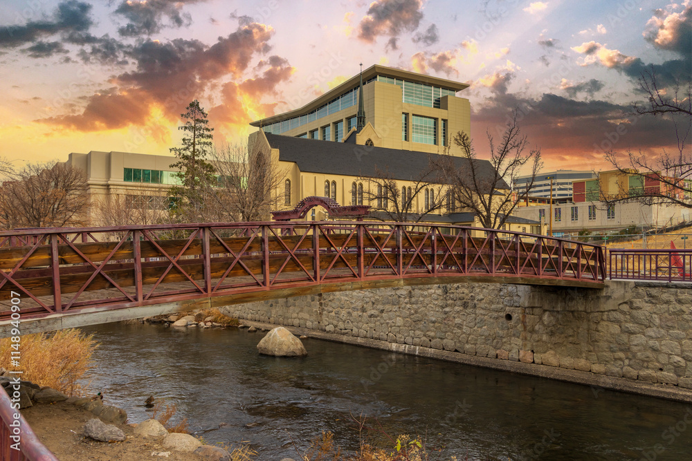 Fototapeta premium A rusty colored bridge over the Truckee River with autumn trees and plants at sunset in Reno Nevada USA