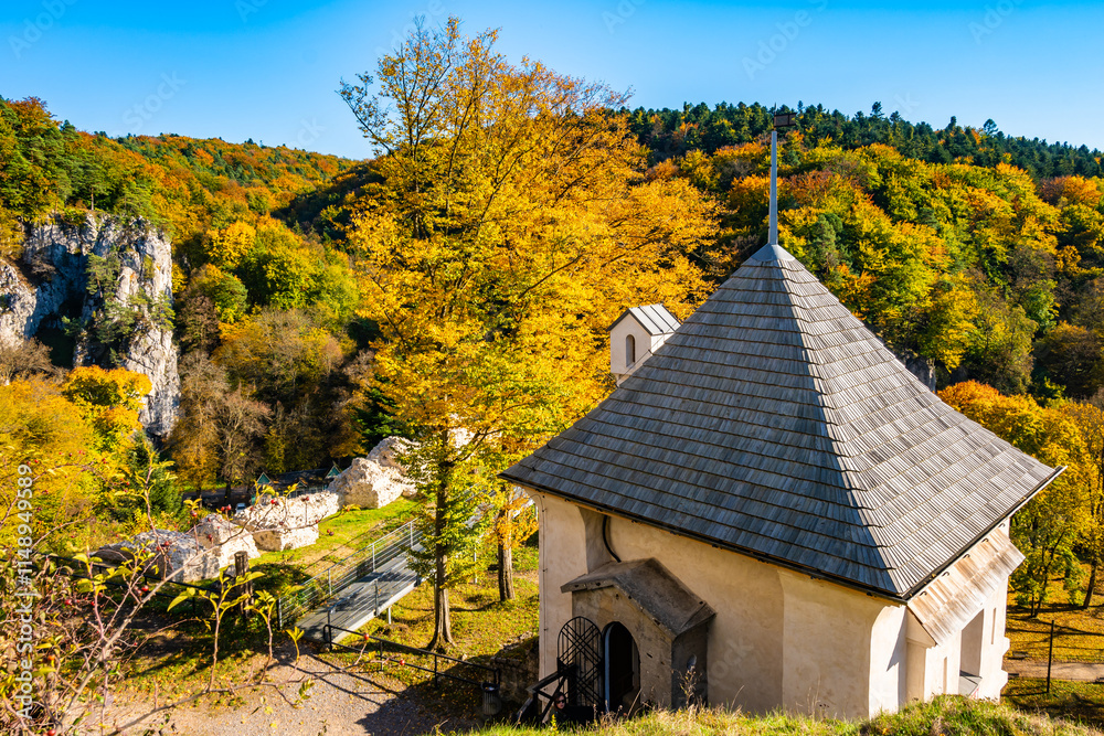 Viewpoint platform in castle park with autumn fall colors of trees in Ojcow National Park, Poland