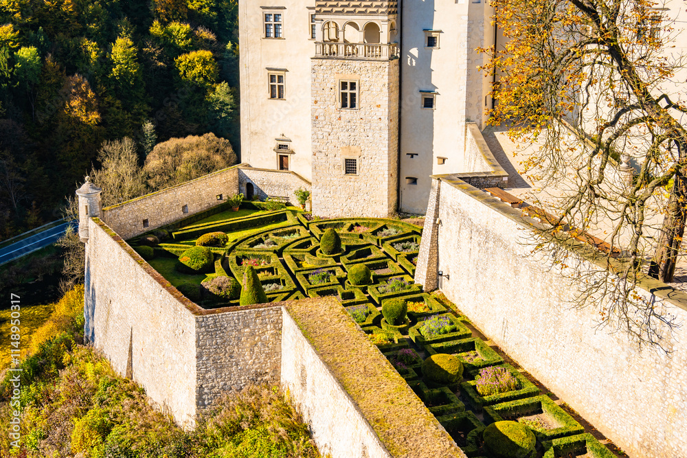 View of Pieskowa Skala castle gardens in park with autumn fall colors of trees in Ojcow National Park, Poland