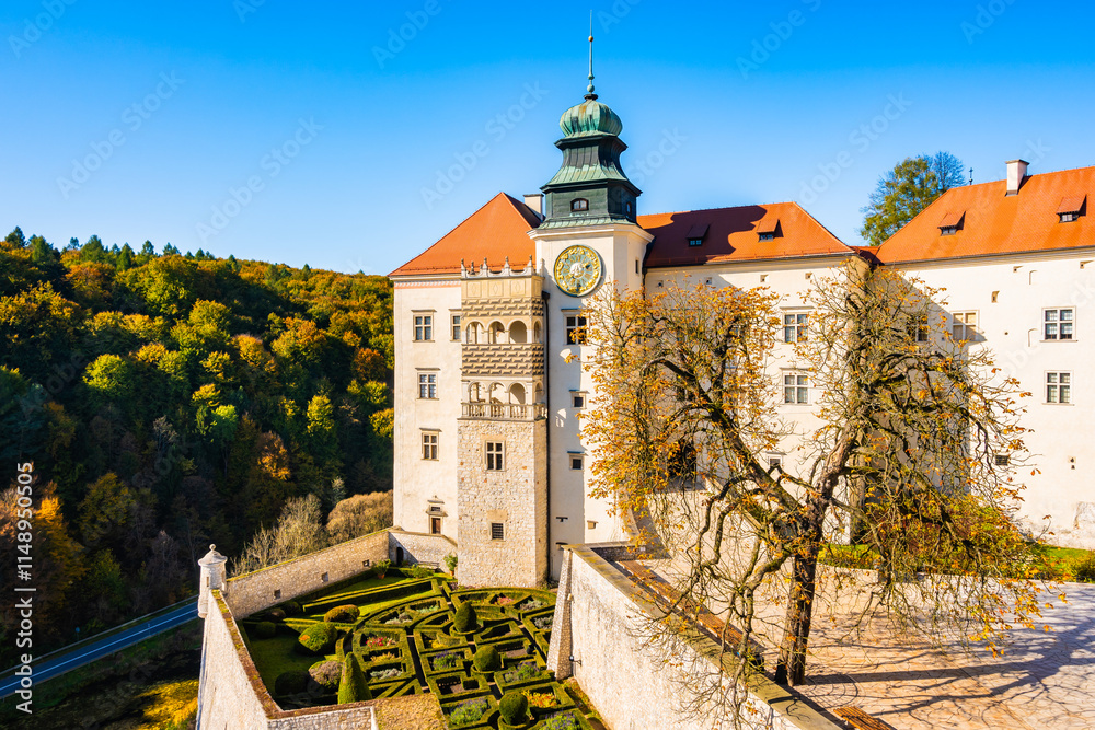 View of Pieskowa Skala castle in park with autumn fall colors of trees in Ojcow National Park, Poland