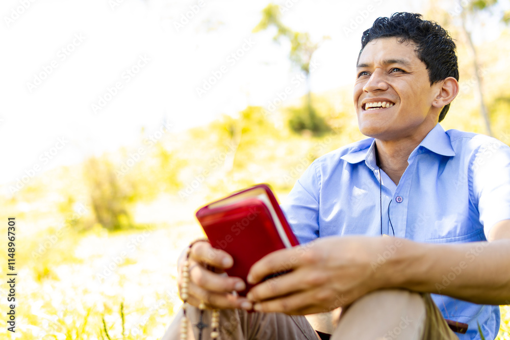Fototapeta premium Christian man holding a Bible outdoors, reflecting tranquility and connection with God