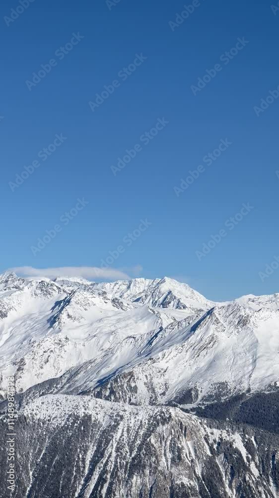 French alps on a sunny day under the clouds by winter covered with snow French alps on a sunny day under the clouds by winter covered with snow