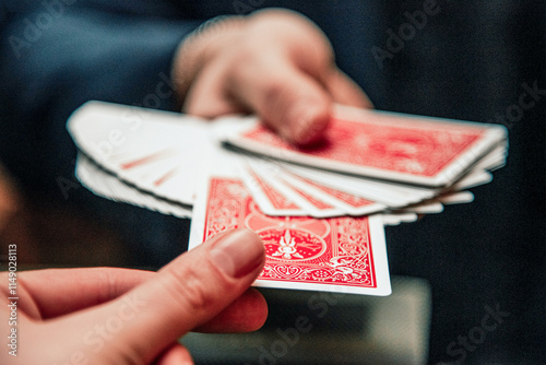 Schilderij op canvas Magician show card trick, man play casino gambling, close up hands holding deck