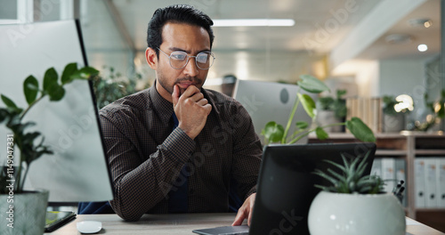 Thinking, research and Asian man in office with laptop for proofreading, creative agency or self publishing. Online, story or entrepreneur with ideas, technology and editing of ebook novel for review photo