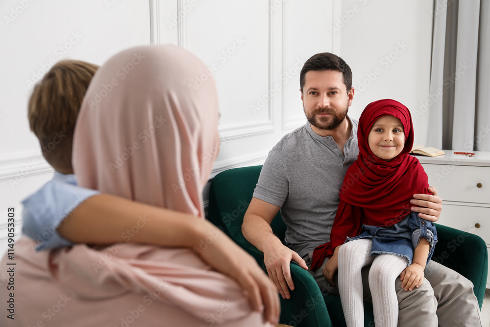 Happy Muslim family spending time together at home