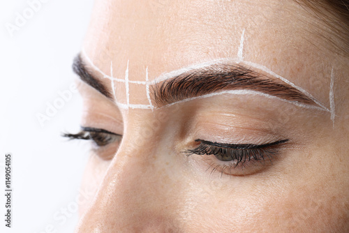 Young woman during henna eyebrows dyeing procedure on white background, closeup