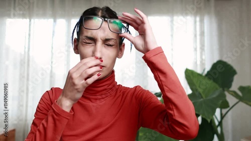 Hispanic Young woman experiencing eye strain or eye pain with glasses close up