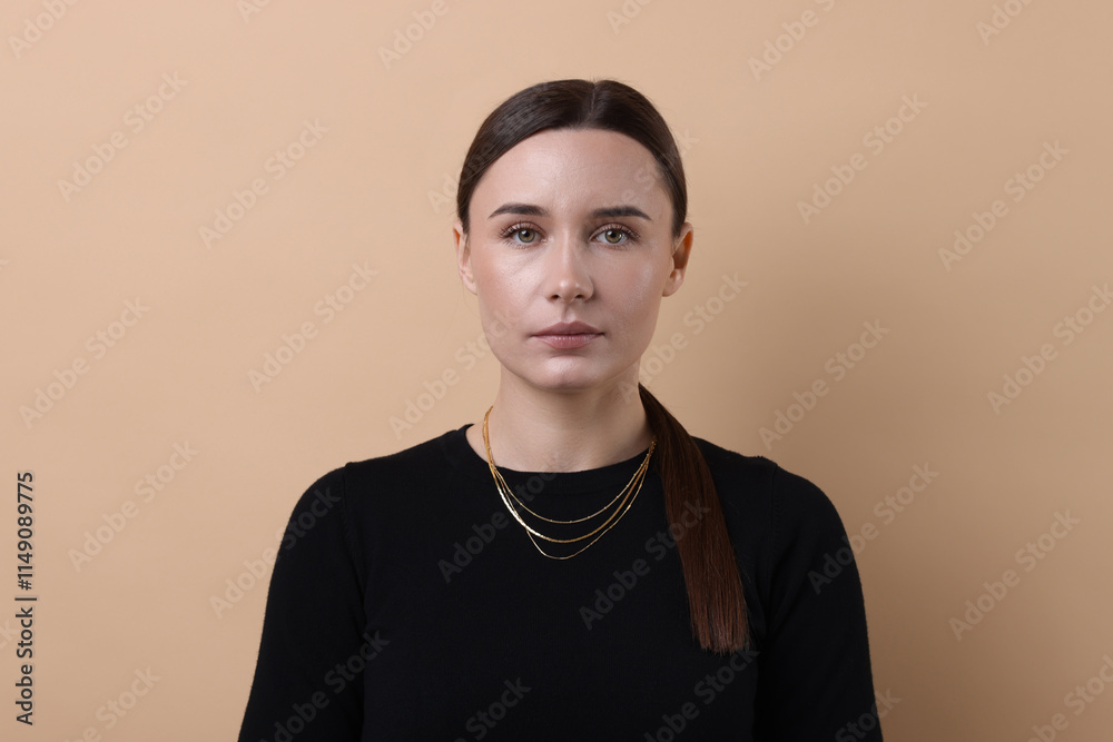 Fototapeta premium Portrait of beautiful businesswoman on beige background