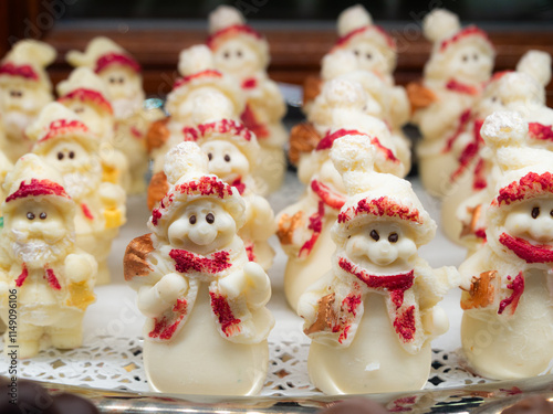 Delightful edible Christmas figurines made of white and red candy, featuring black eyes. These handmade sweets from Florence, Italy, add a sweet touch to your holiday decorations and treats.