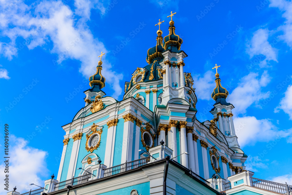Fototapeta premium The blue and white church has a tall steeple and crosses on top