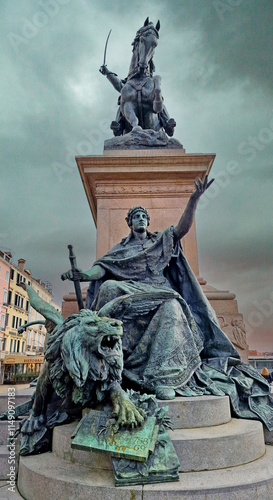 Winged lion statue at the Victor Emmanuel II Monument, Venice, Italy cloudy day photo