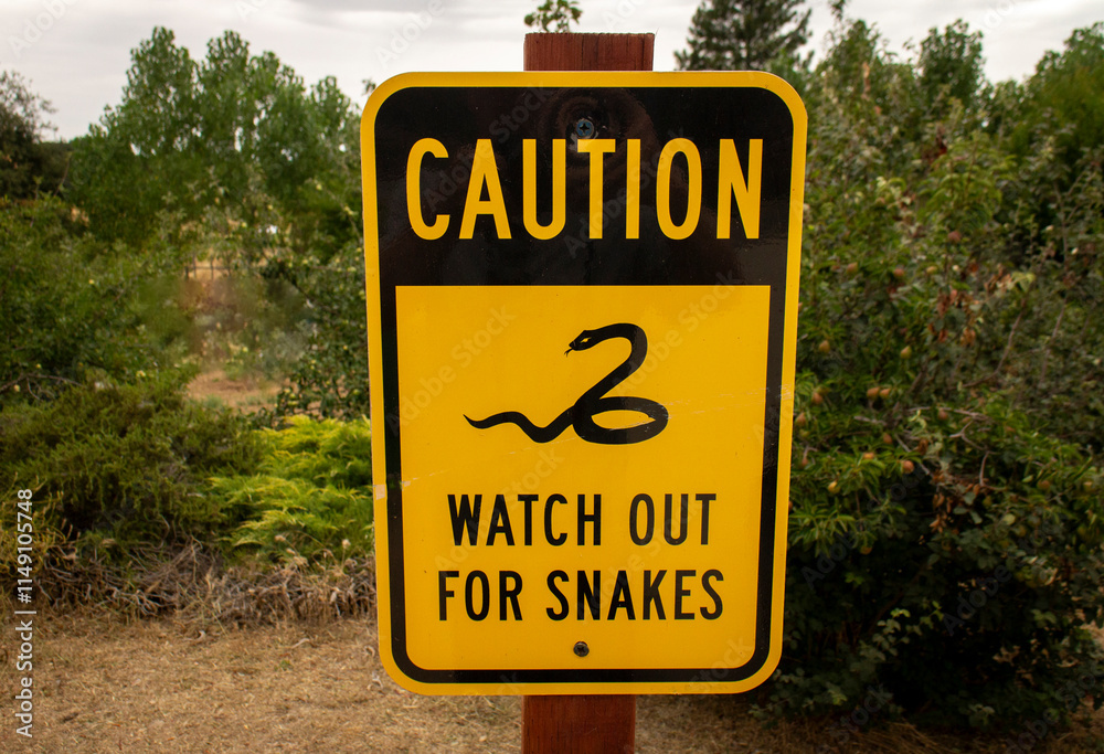 Sign warning to watch for snakes in a wilderness area