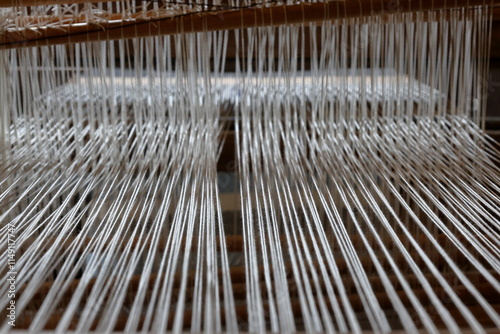 White threads pattern. Old school weaving machine. Close up.