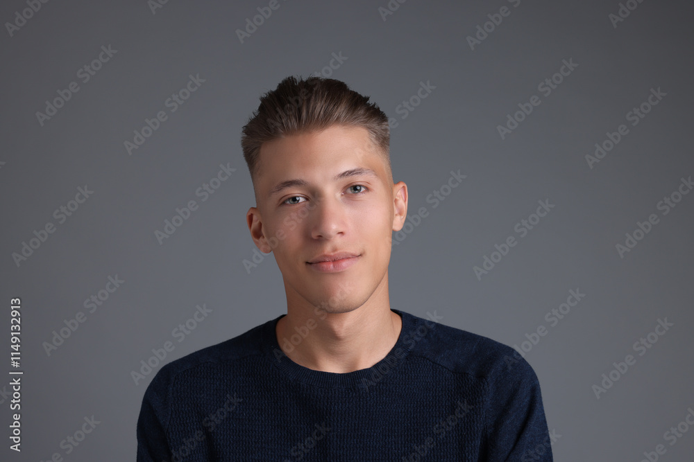 Handsome young man with stylish haircut on grey background Handsome young man with stylish haircut on grey background