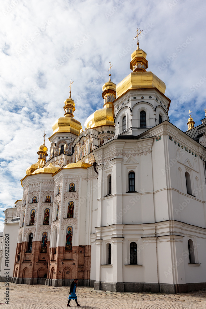 Fototapeta premium A large white building with gold domes and a gold cross on top