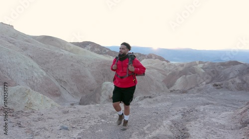 A dedicated hiker explores the stunning landscapes of Death Valley National Park, immersed in the warm desert sun with a wellpacked backpack full of essentials for a day of adventure photo