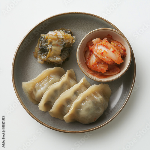 Artistic shot of mandu dumplings with a side of kimchi, minimalist background, soft lighting  photo