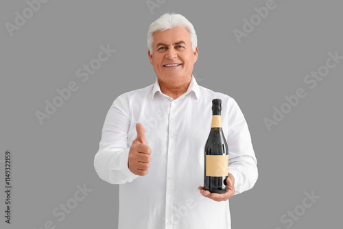 Senior man with bottle of c...
