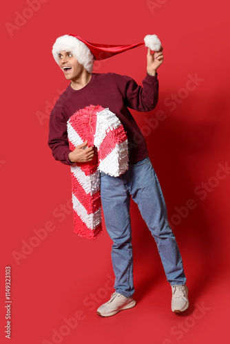 Happy young man in Santa ha...