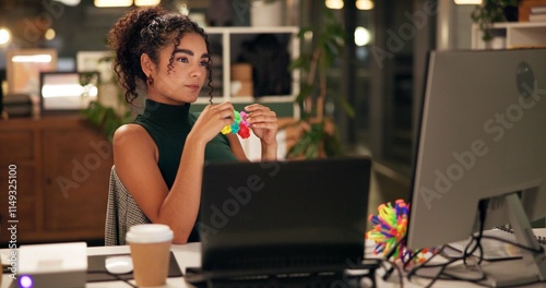 Business woman, computer and thinking with popit toy, creative agency and ideas for night brainstorming. Girl, brand consultant or multi screen laptop with project, proposal or office fidget stimming