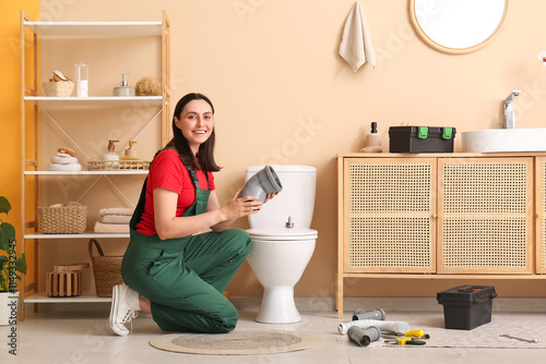 Female plumber installing t...