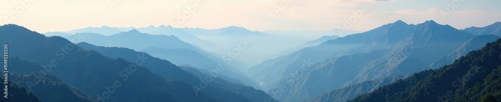 Fototapeta premium Mountain peaks and valleys in the distance with a misty atmosphere, atmospheric conditions, mist