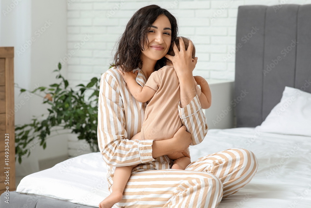 Happy mother hugging her little baby on bed at home Happy mother hugging her little baby on bed at home