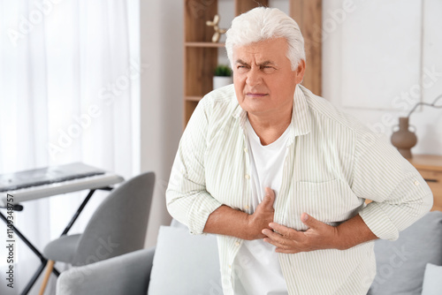 Mature man having heart att...