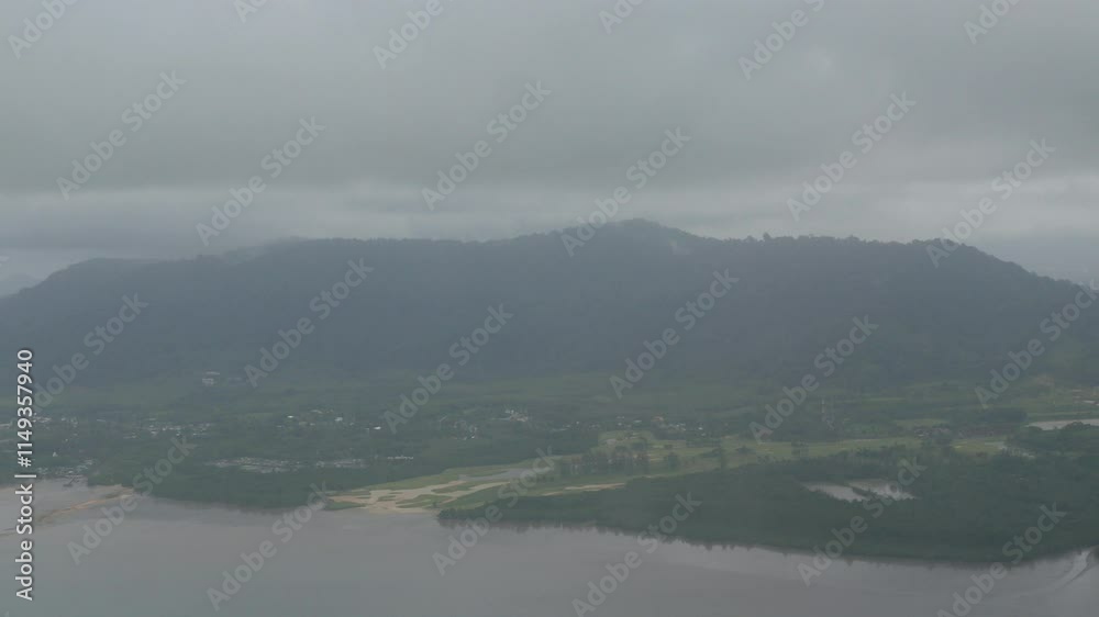 view from plane over sky with green mountain range landscape area near sea coastal in rainy day at phuket in Thailand.nature lanscape from airplane for transportation holiday background concept. view from plane over sky with green mountain range landscape area near sea coastal in rainy day at phuket in Thailand.nature lanscape from airplane for transportation holiday background concept.