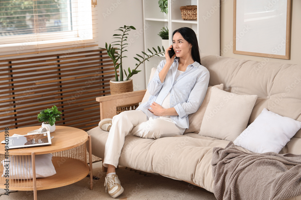 Young pregnant woman talking by mobile phone on sofa at home Young pregnant woman talking by mobile phone on sofa at home