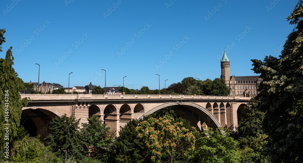 Fototapeta premium Scenic Adolphe Bridge and Spuerkeess Tower View on a Summer Day - Luxembourg City