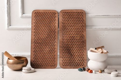 Sadhu boards with Tibetan singing bowl and palo santo on white wooden background