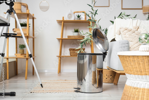 Foto Interior of stylish living room with grey sofa and trash bin