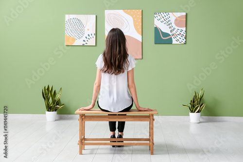 Young woman sitting on benc...