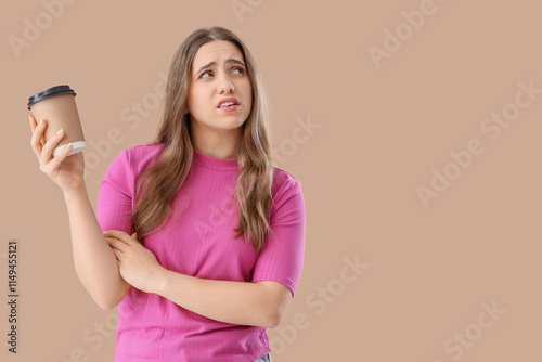 Thoughtful woman holding cu...