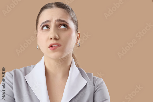 Thoughtful maid on beige ba...