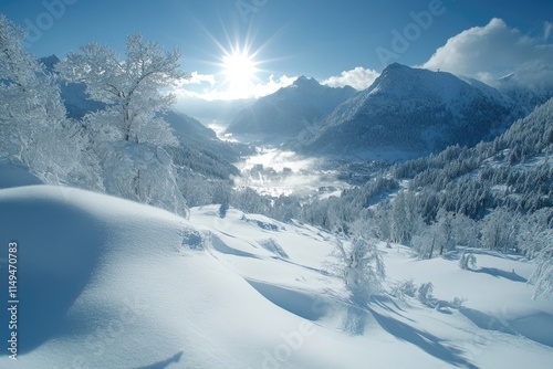 Sun shining over snowy mountain valley and frozen trees