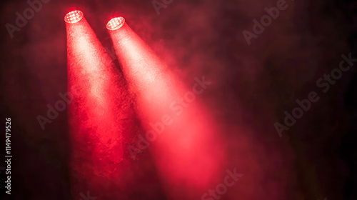 Red stage spotlights illuminating through smoke in a concert setting