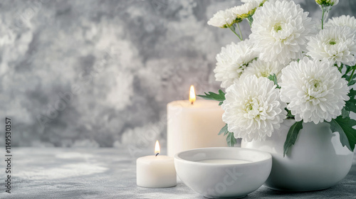 White chrysanthemums and candles in serene still life setting