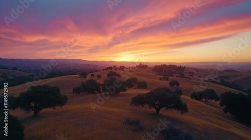 Vibrant Sunset Over Rolling Hills Landscape photo